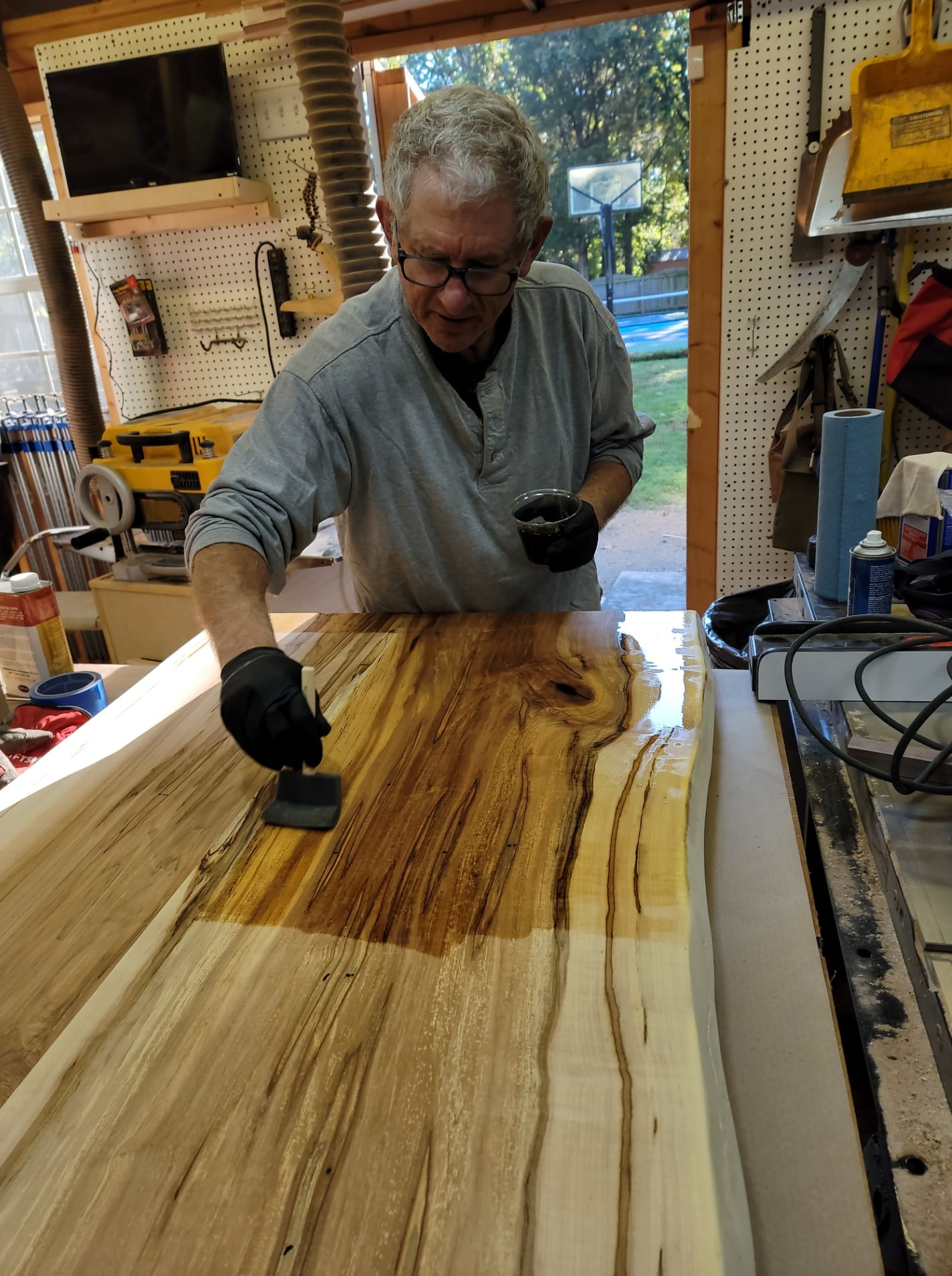 Jon applying finish to live edge table